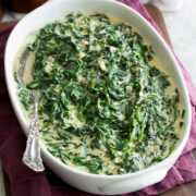 Homemade creamed spinach in a white oval serving dish.