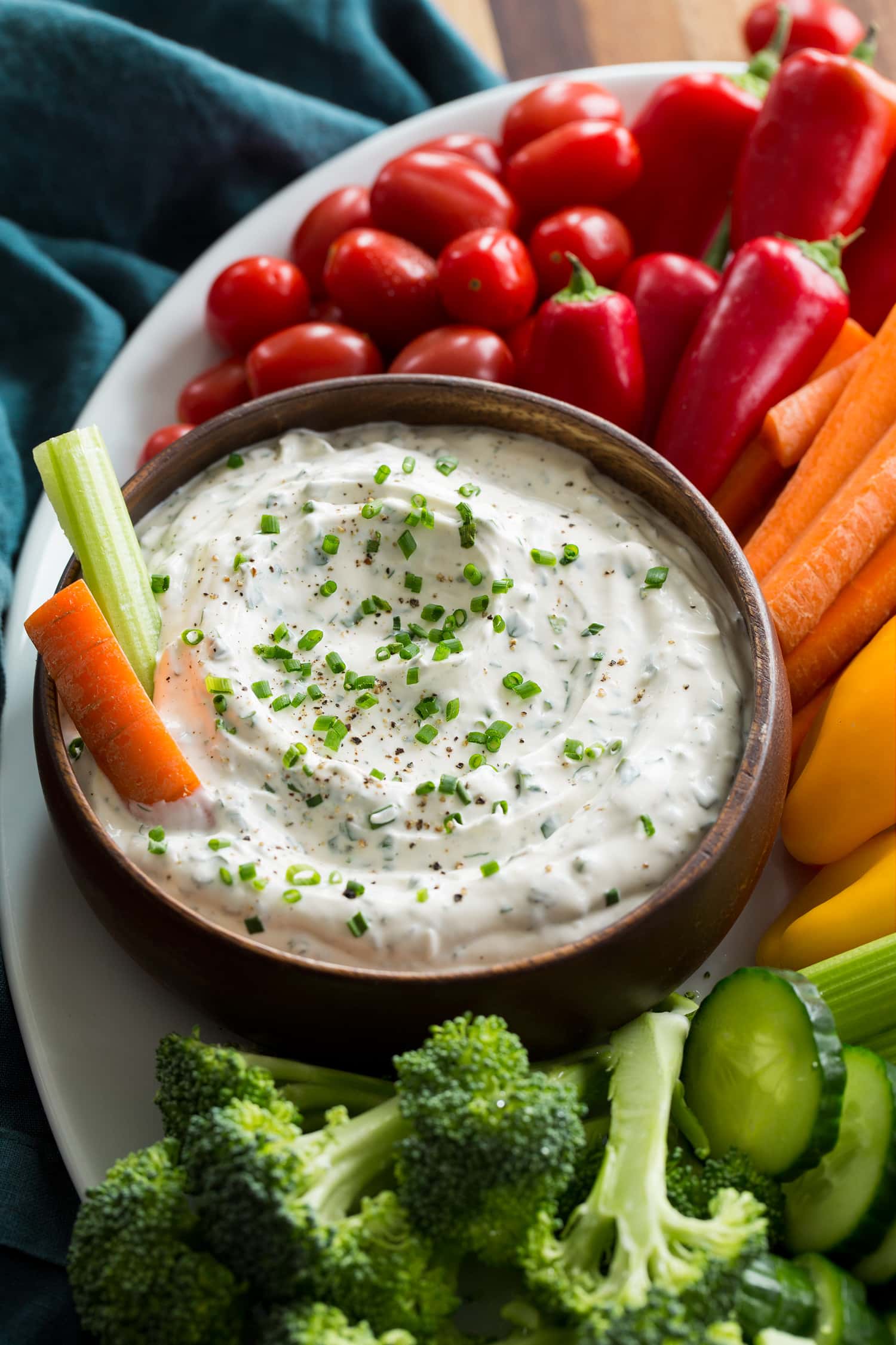 Close up photo of ranch dip in a wooden bowl.
