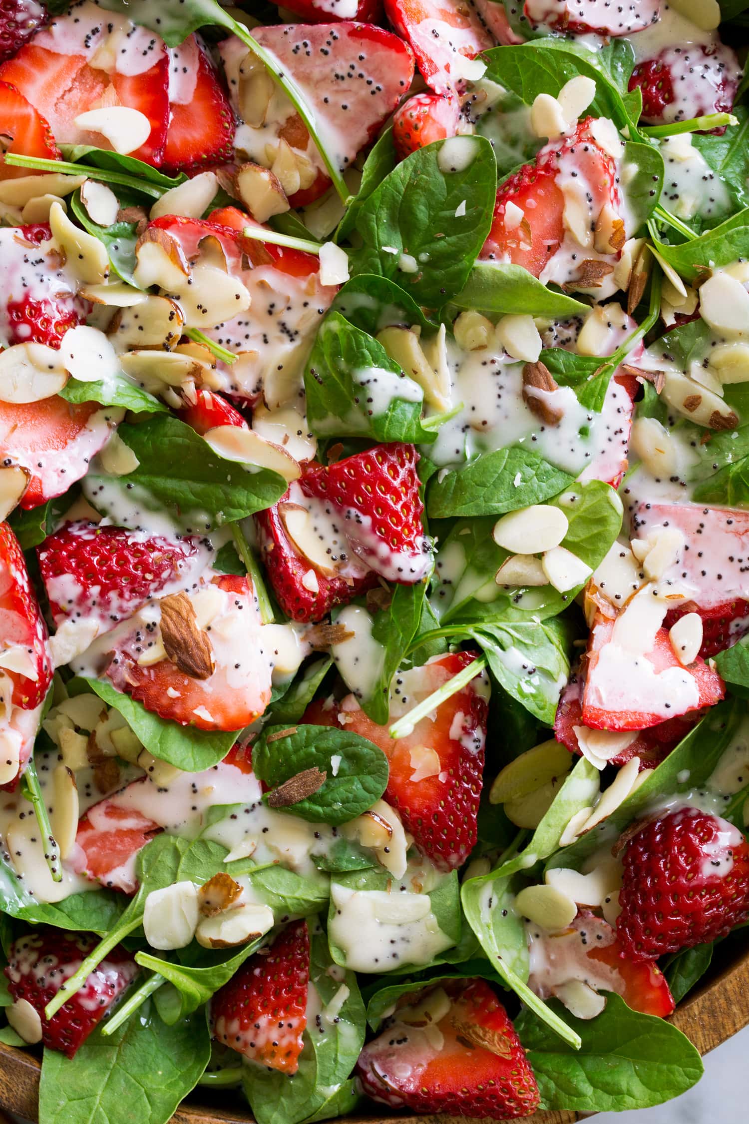 Close up photo of strawberry spinach salad with almonds.