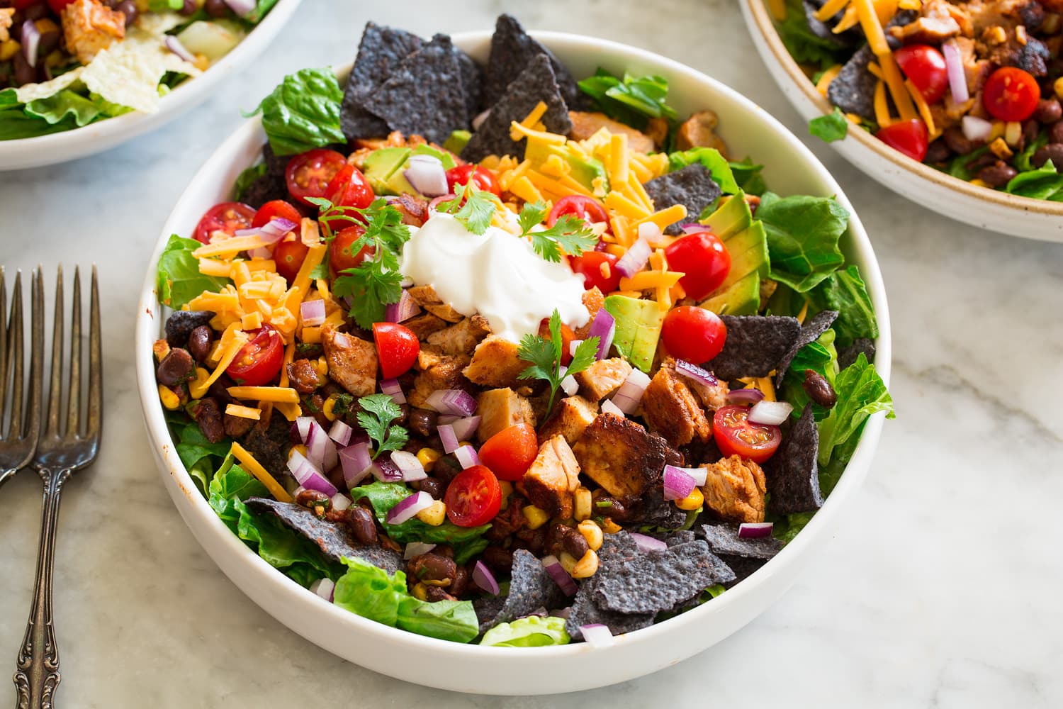 Layered taco salad with all prepared ingredients.