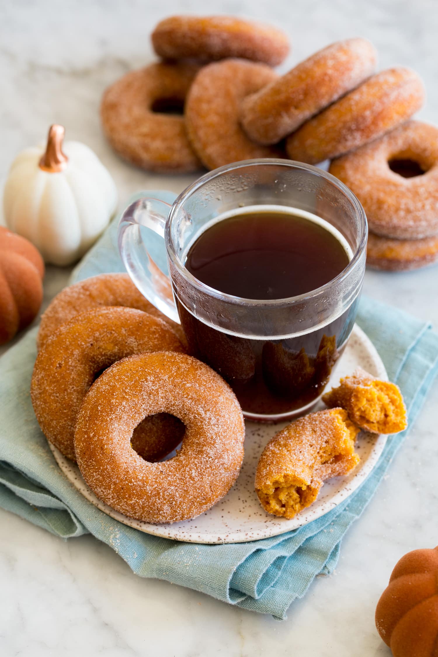 Baked donuts served with a cup of coffee.