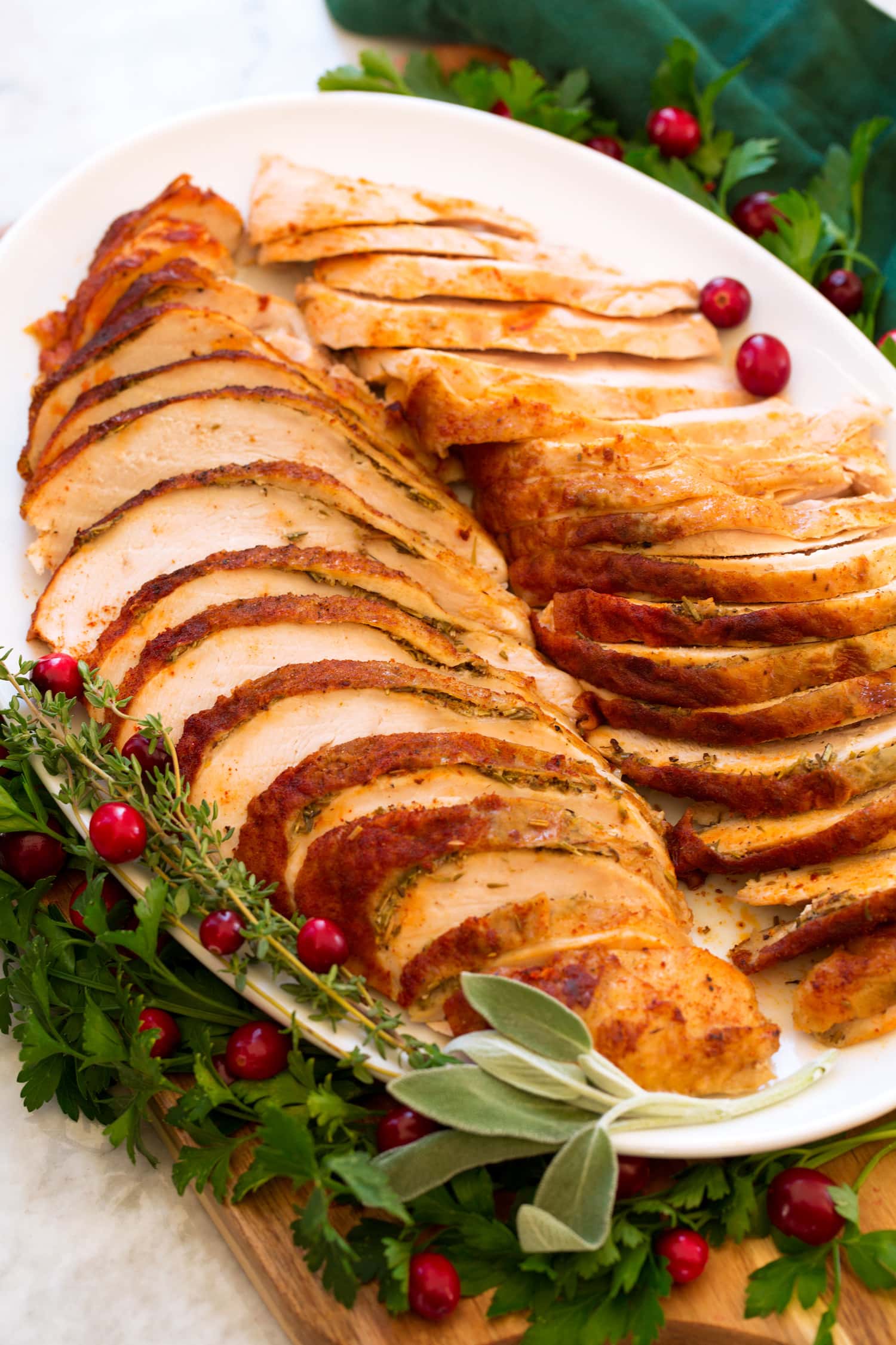 Side angle of cooked turkey breast on a platter.