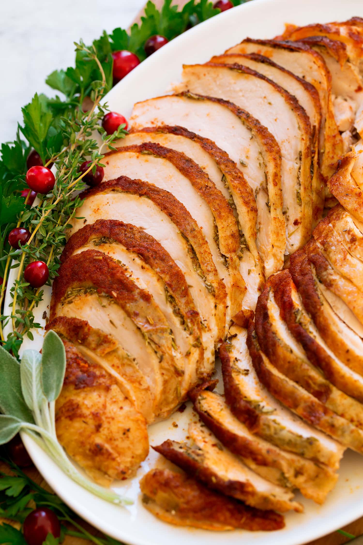 Close up photo of cooked crockpot turkey breast with herbs.