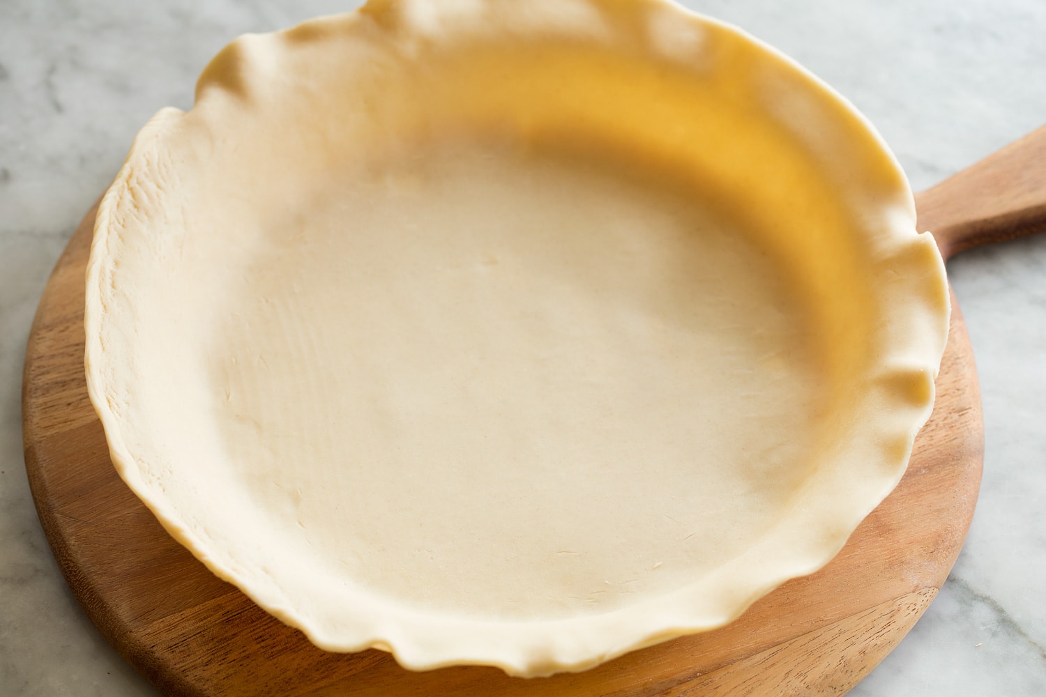 Laying crust in pie dish.