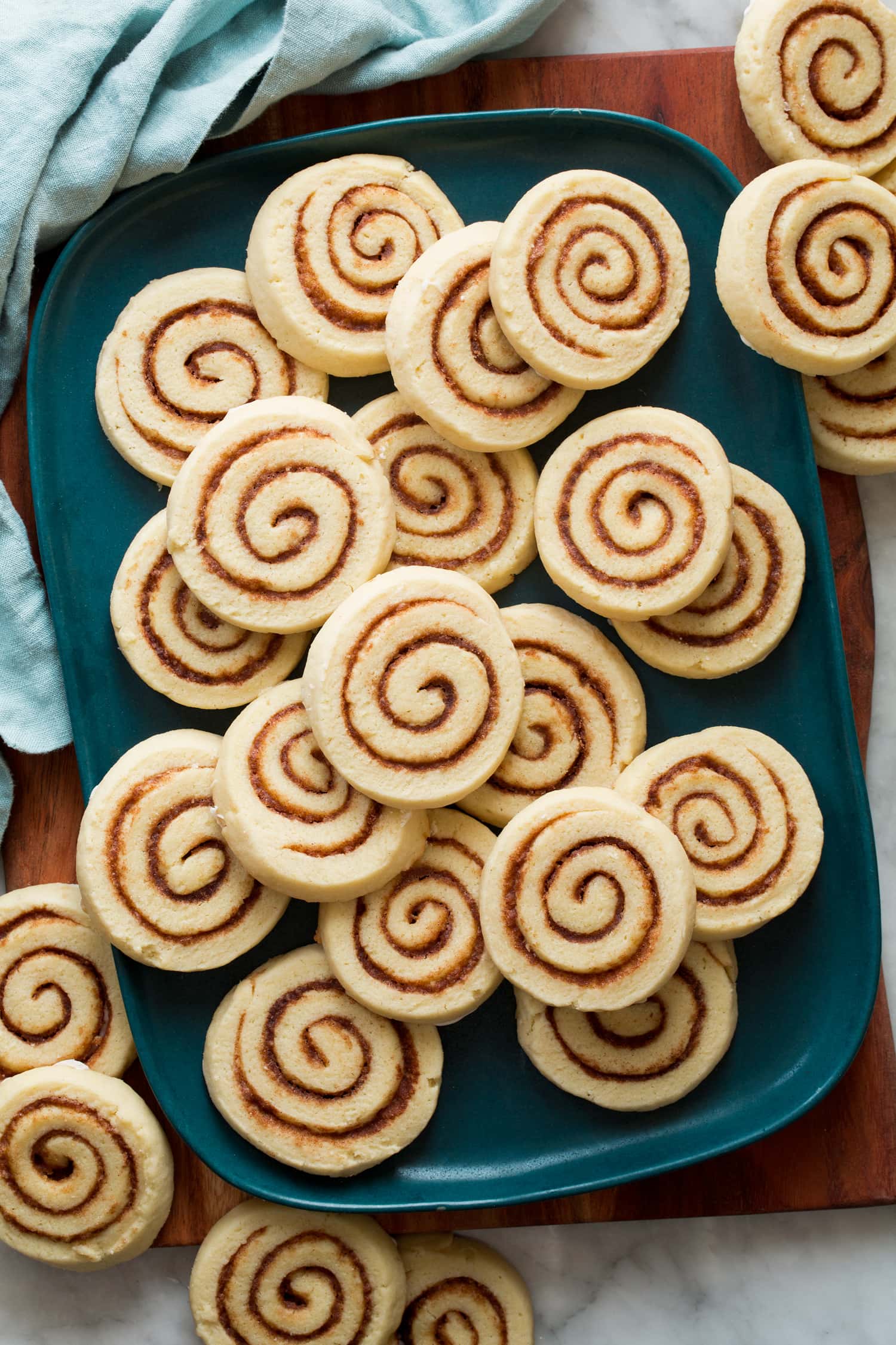 Sliced soft cream cheese cinnamon roll cookies showing pretty cinnamon sugar swirl.