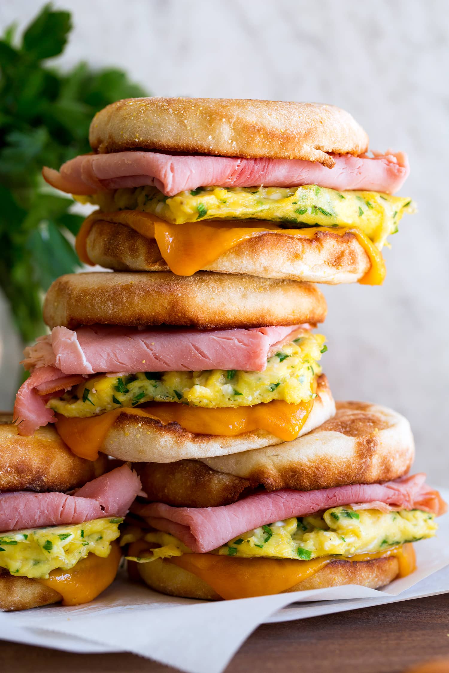 Breakfast sandwiches shown in a stack close up.