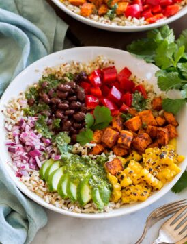 Baja grain bowl with black beans, tomatoes, sweet potatoes (or chicken), corn, avocado, red onion, brown rice and quinoa.