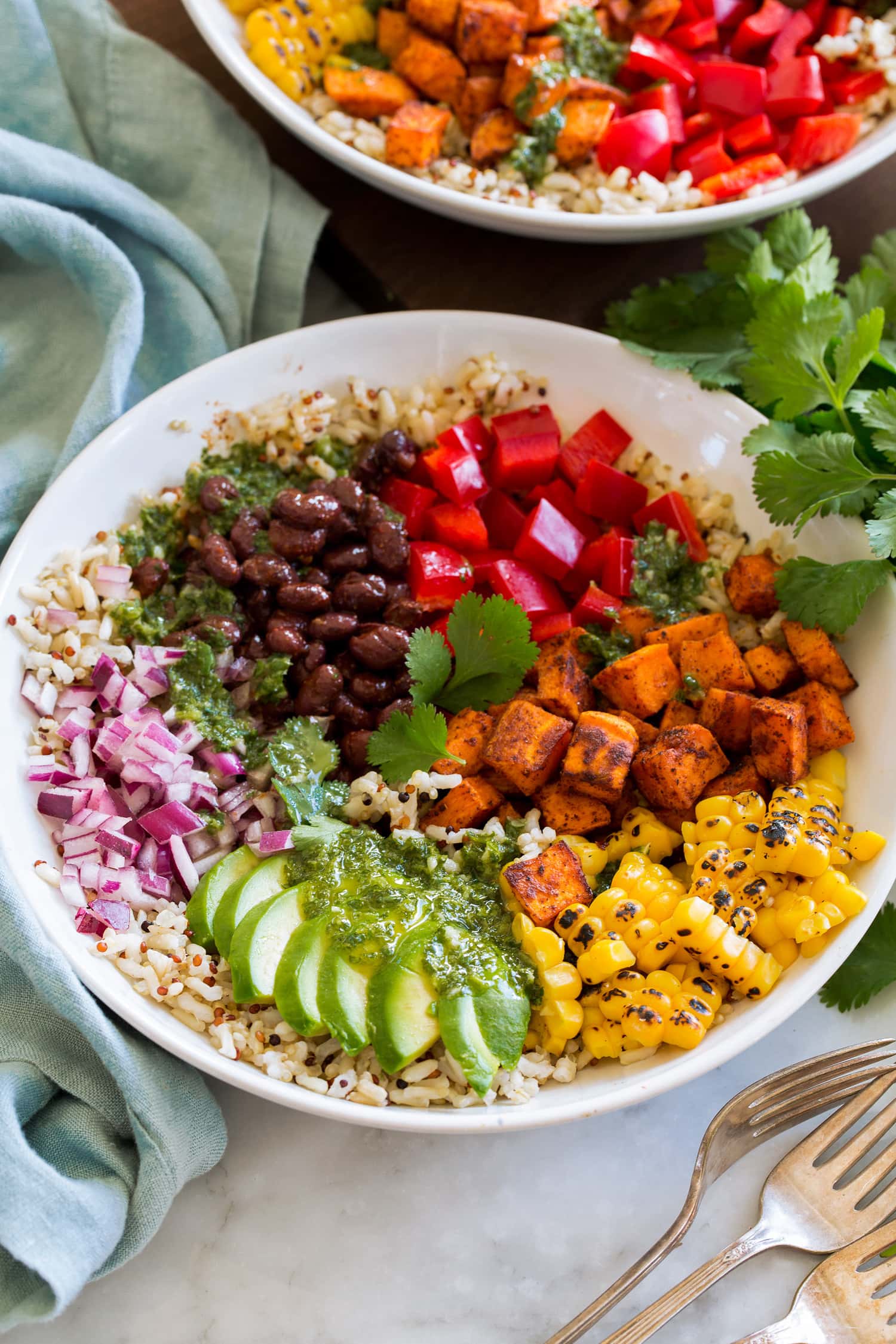 Baja grain bowl with black beans, tomatoes, sweet potatoes (or chicken), corn, avocado, red onion, brown rice and quinoa.