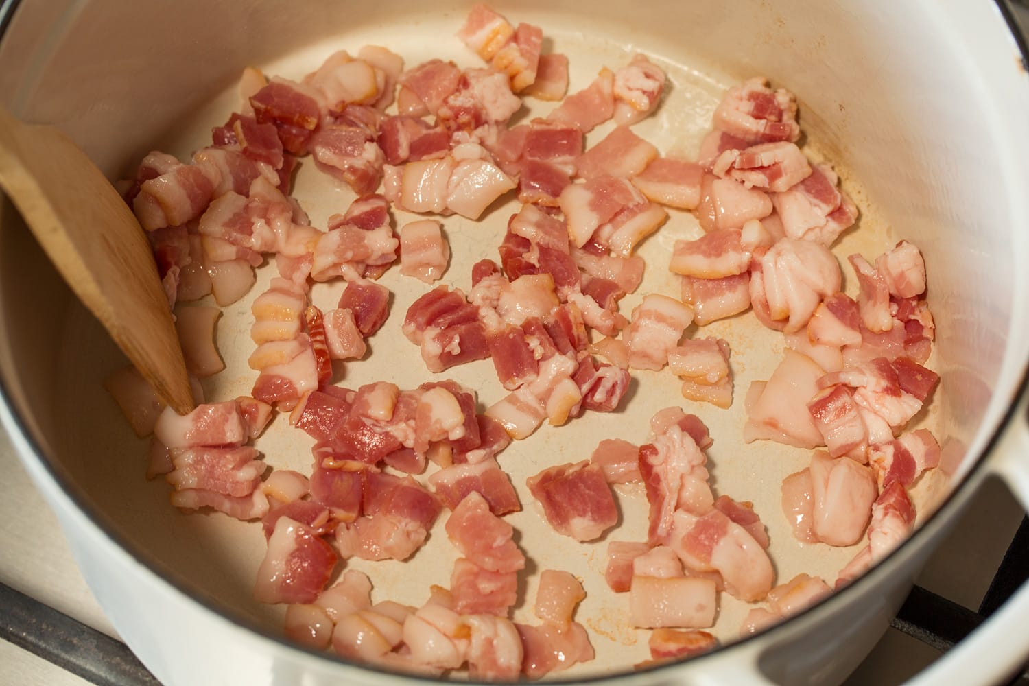 Chopped bacon in a pot before cooking.
