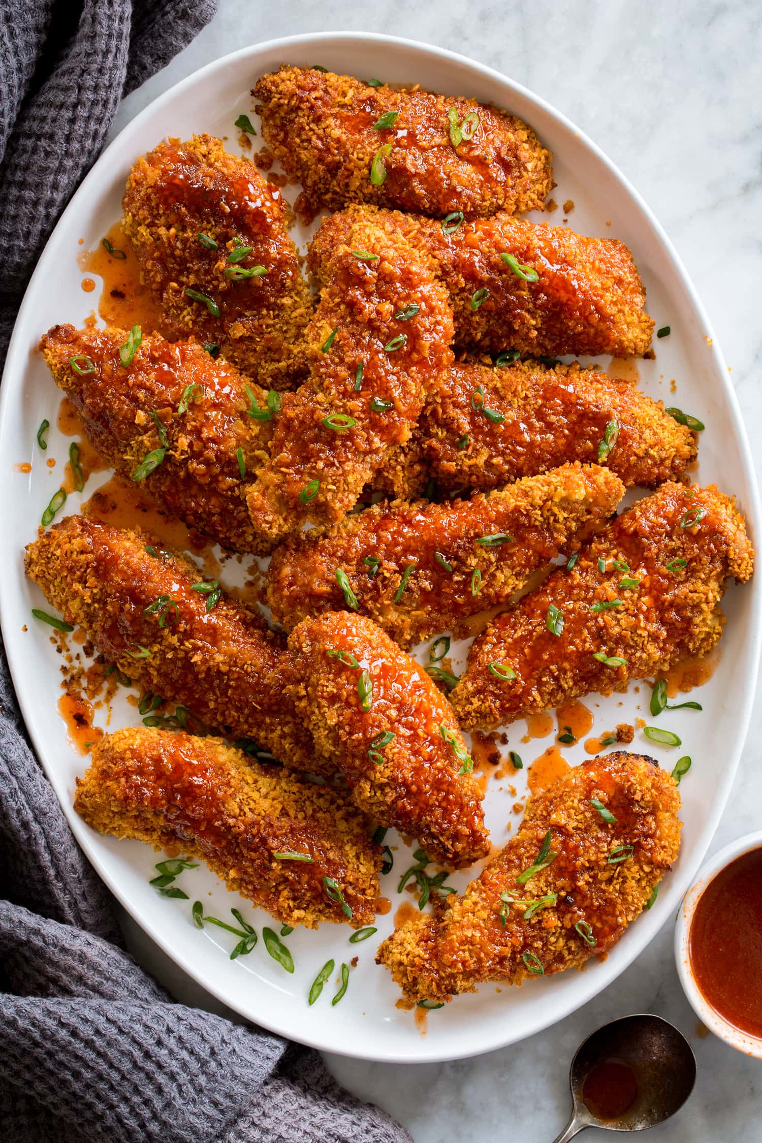 Hot Honey Chicken strips covered with crispy cornflakes and oven baked then drizzled with hot honey sauce.