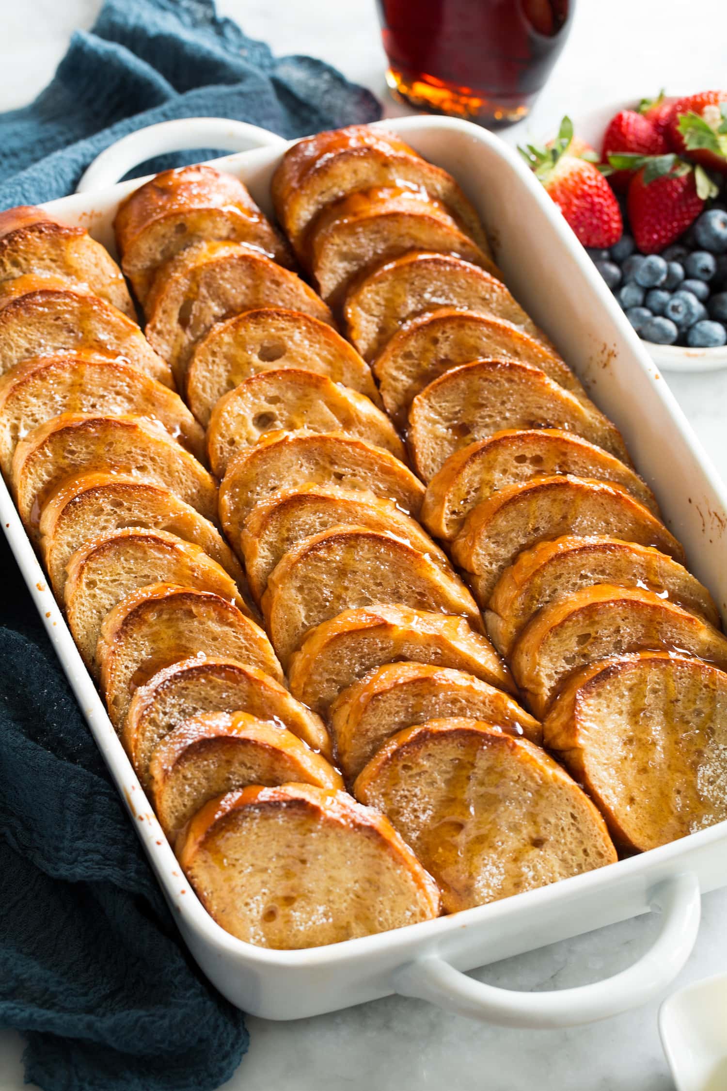 Baked french toast in a white baking dish.
