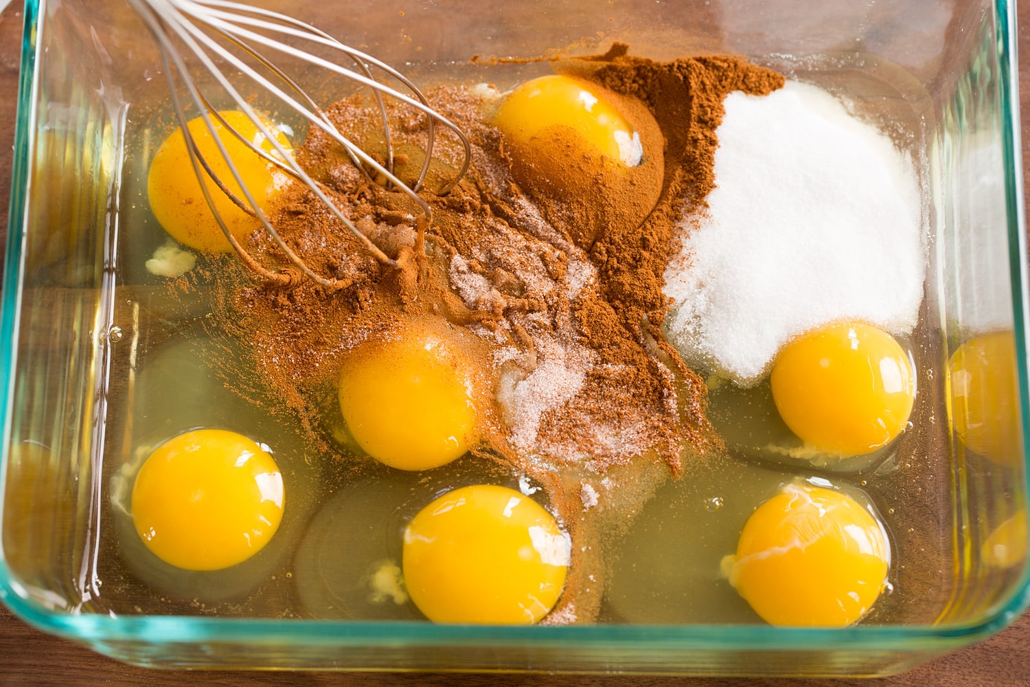 Eggs, sugar and cinnamon in shallow mixing dish.