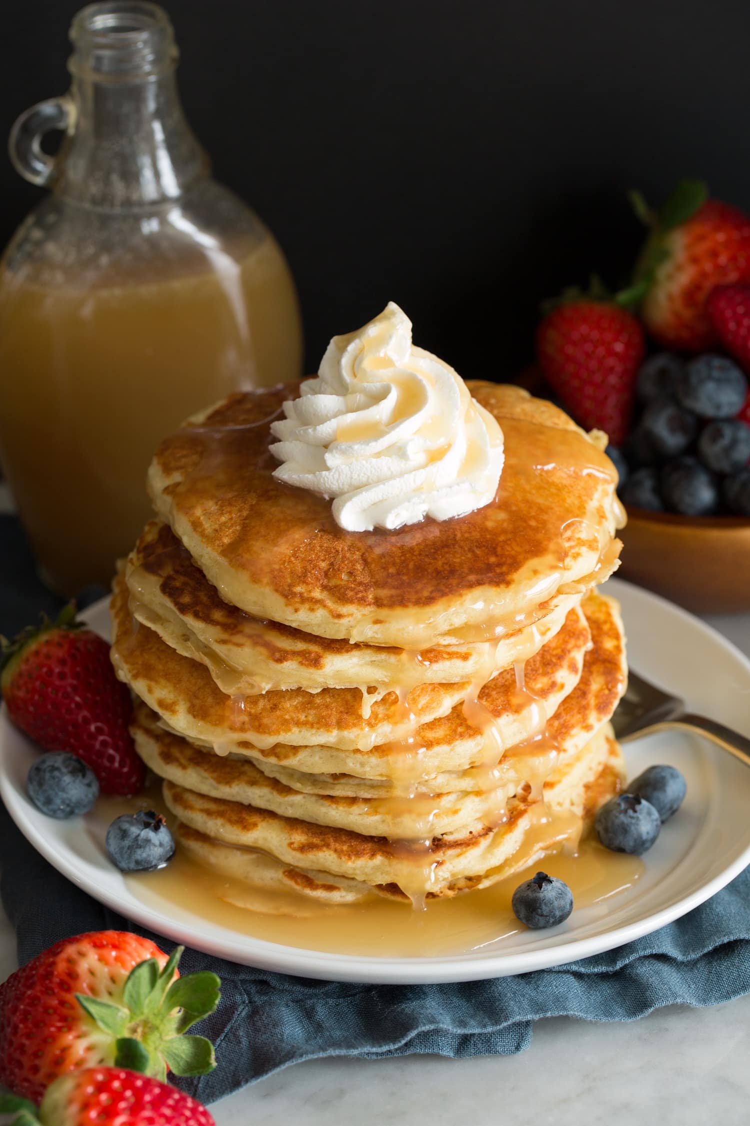 Homemade vanilla buttermilk syrup over pancakes with fresh fruit.