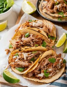 Pork carnitas shown in tortillas as tacos.