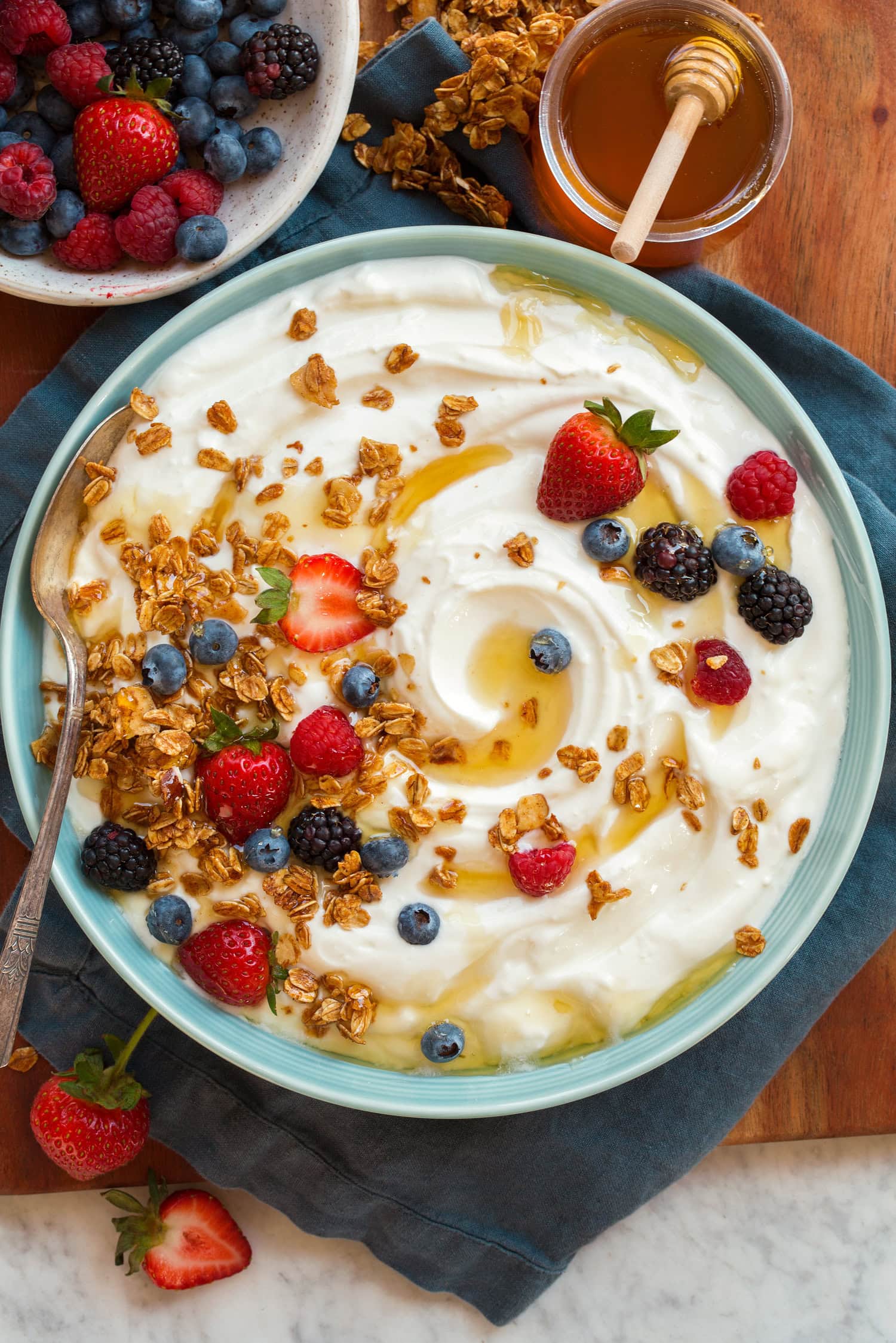Plain homemade yogurt with fruit and granola atop. Shown from overhead. - 14