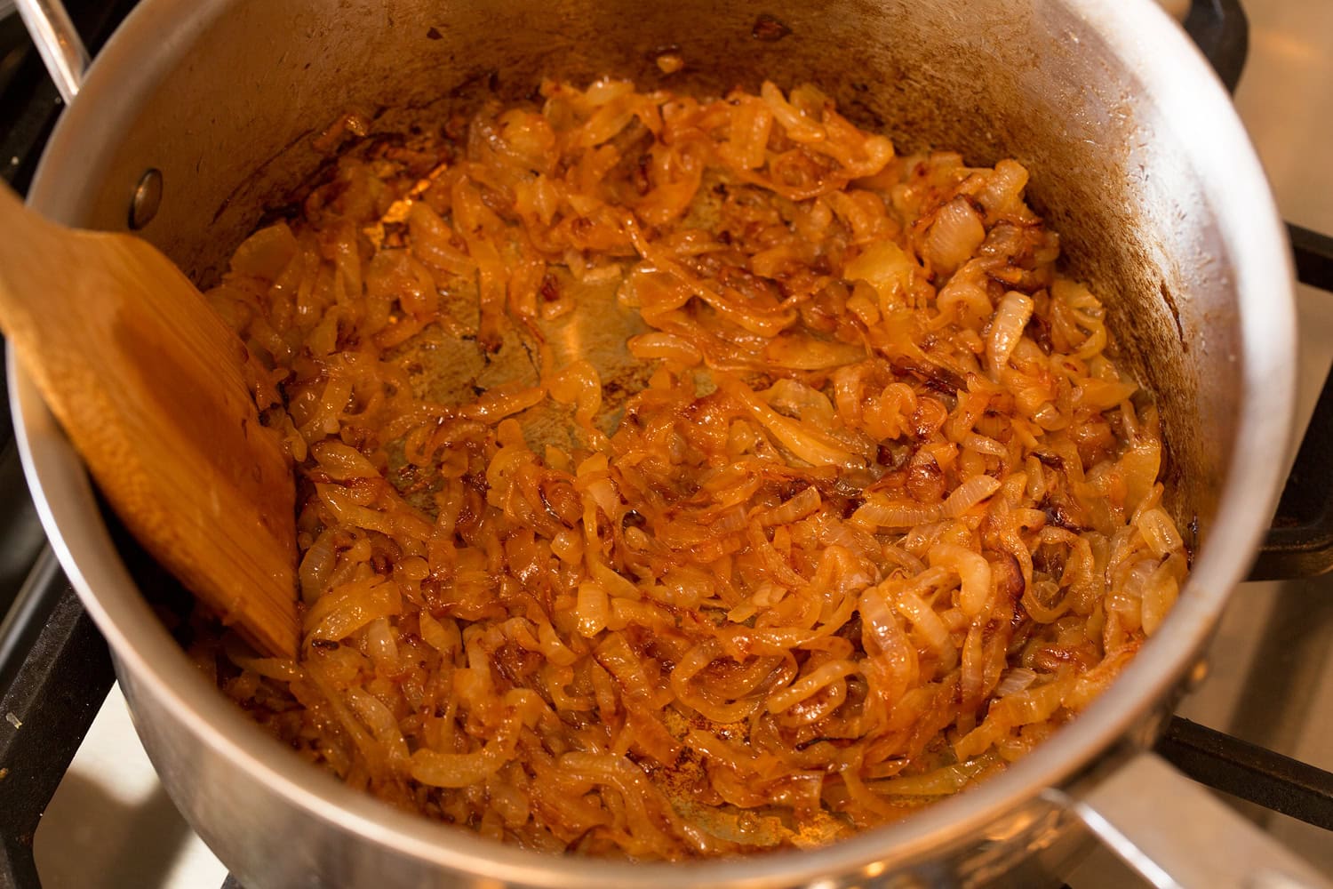 Onions in a saucepan shown after caramelizing. 