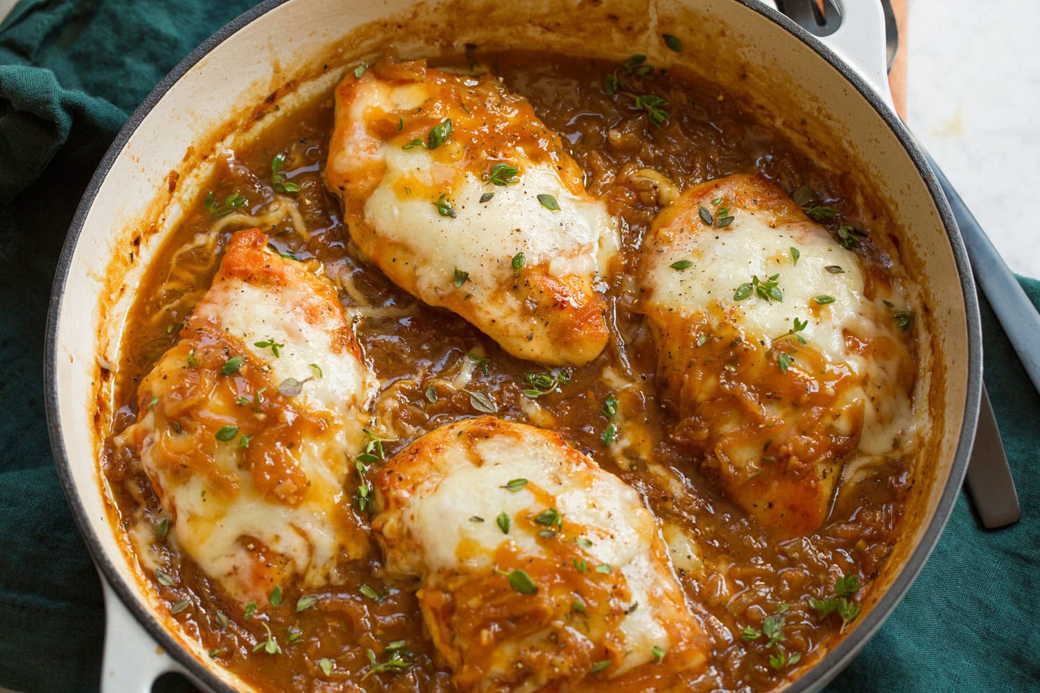 Cheese shown after melting on chicken breasts.