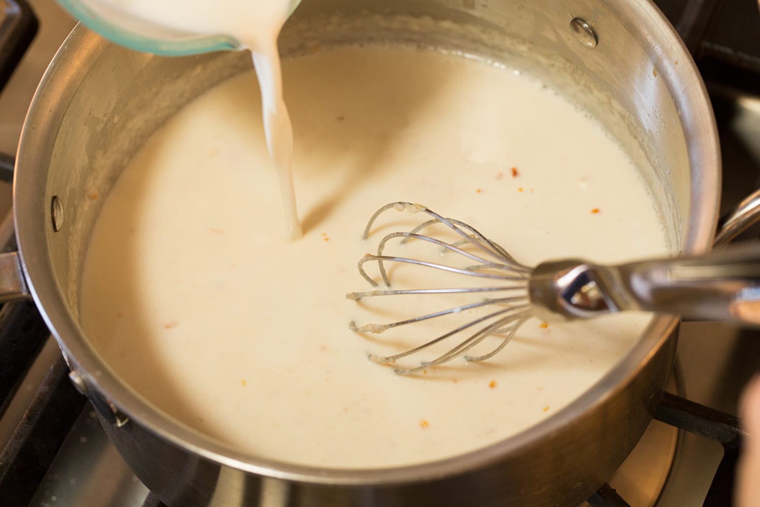 Funeral Potatoes Milk mixture whisked into rough in saucepan.