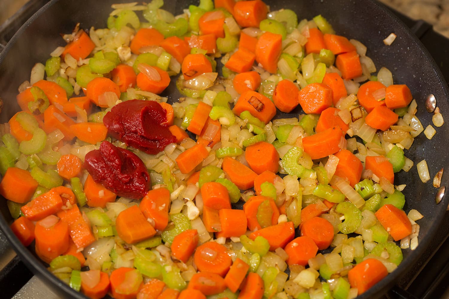 Tomato paste added to sautéed vegetable mixture.