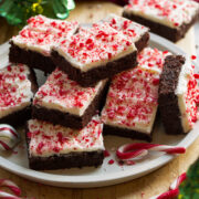 Plate of stacked frosted peppermint brownies.