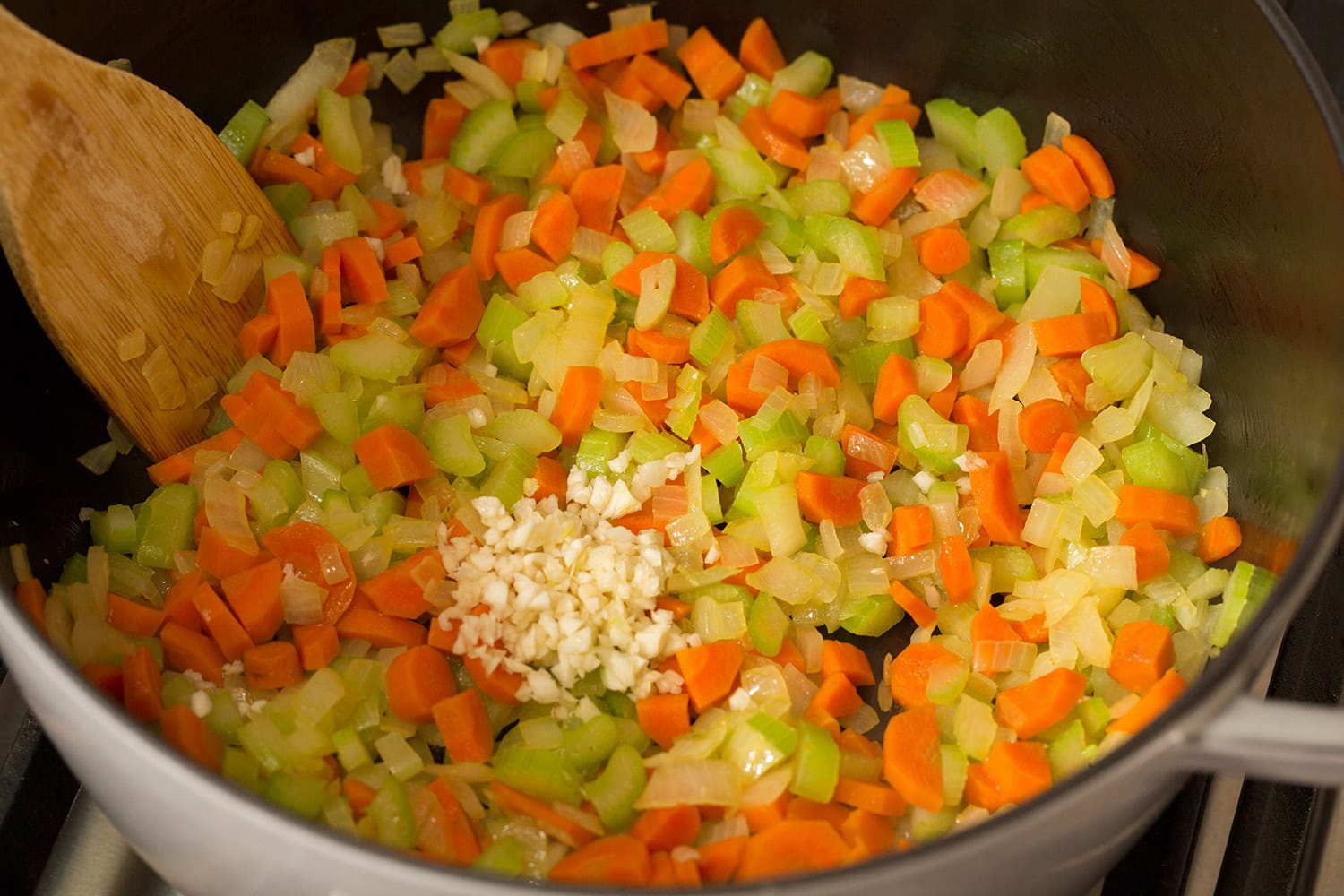 Vegetables sauteed in pot.