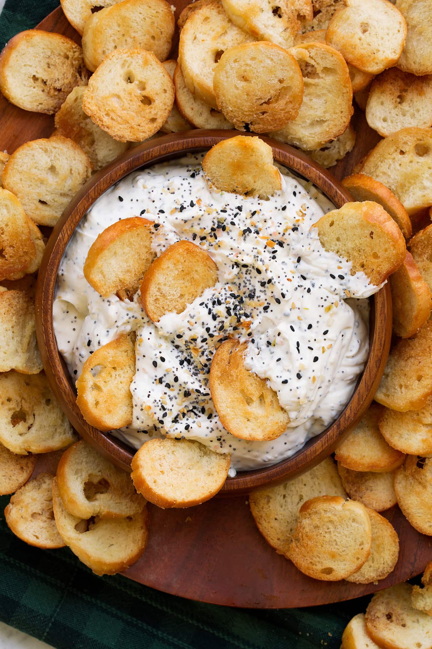 Close up overhead photo of bagel chips dunked in everything bagel dip. - 3