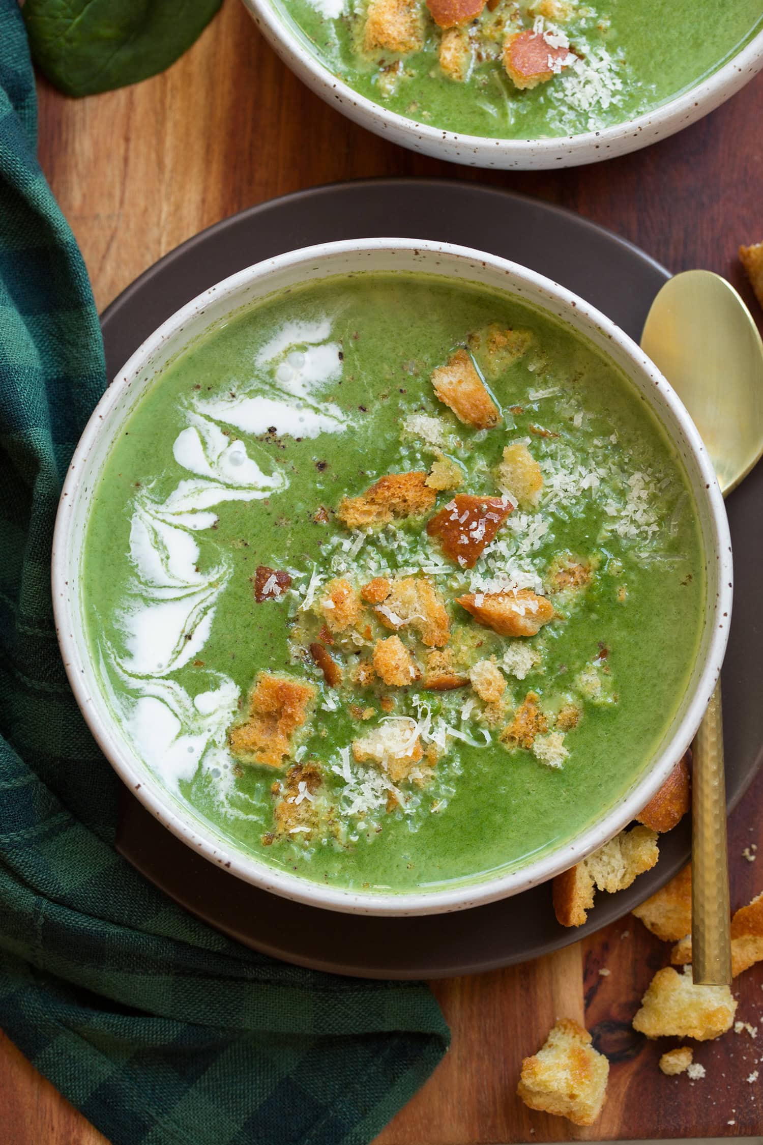 Spinach Soup Overhead photo of homemade spinach soup shown as pureed soup with garnishes.