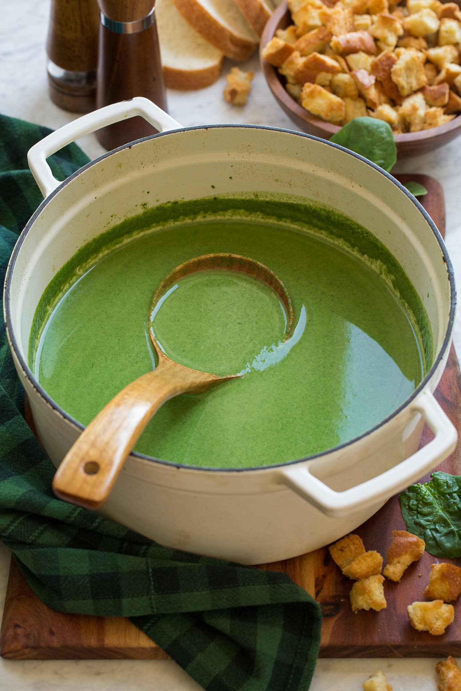 Spinach Soup Homemade cream of spinach soup in a white pot.