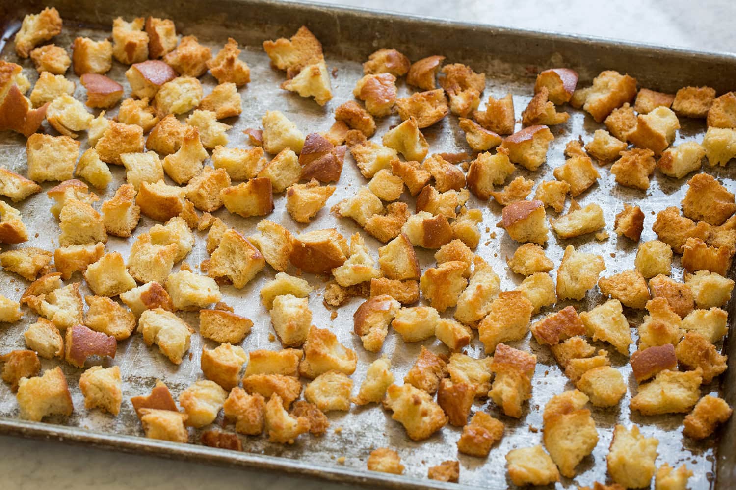 Spinach Soup Homemade rugged croutons shown on a baking sheet.