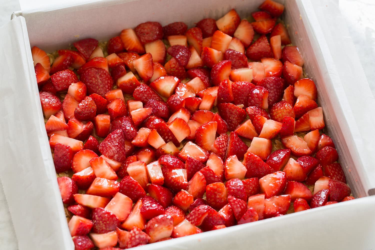 Diced strawberry mixture shown added over oatmeal layer.