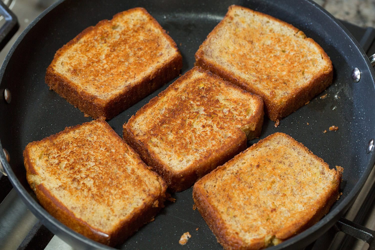 Banana bread shown after toasting in butter on both sides in non-stick skillet.