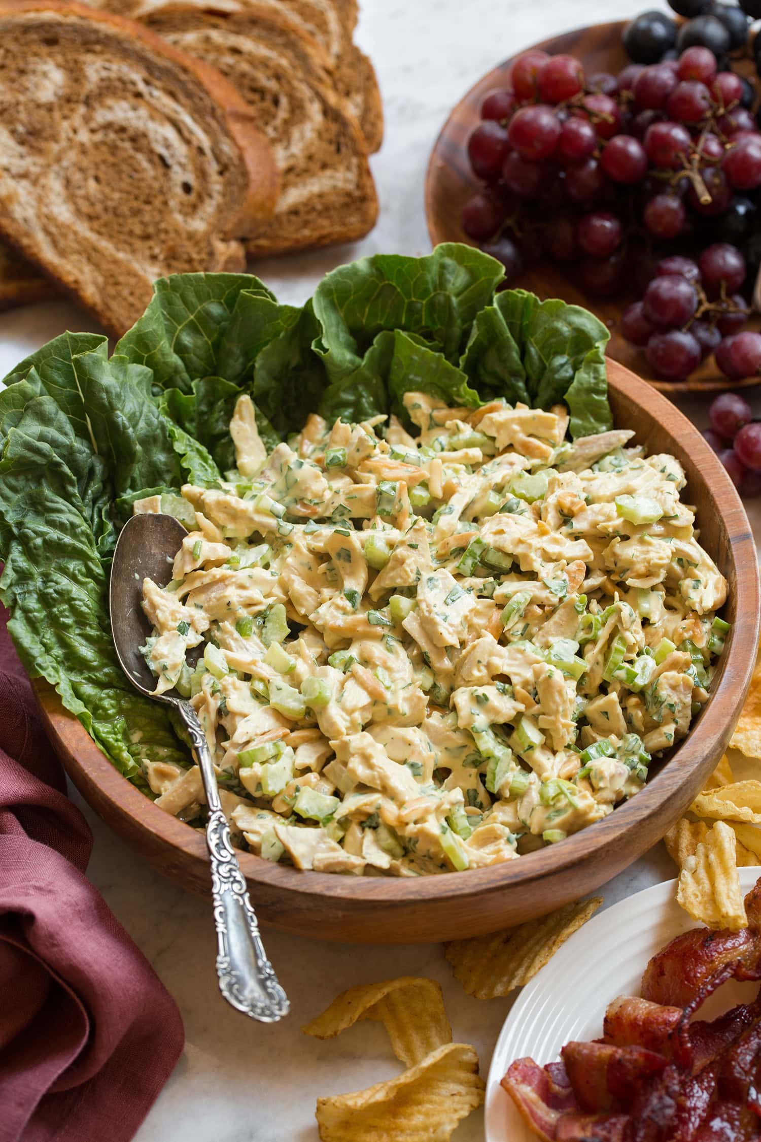 Homemade honey mustard chicken salad with celery and almonds in a bowl.