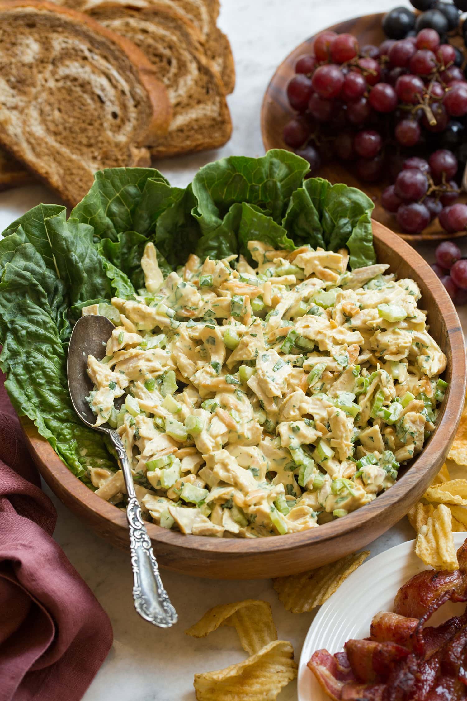 Homemade honey mustard chicken salad with celery and almonds in a bowl.