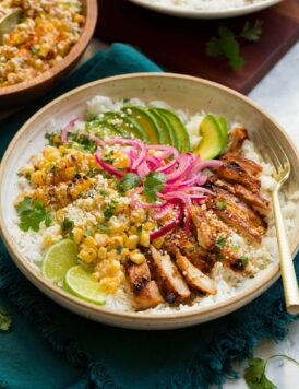Street corn and chicken rice bowl with avocado and pickled red onions.
