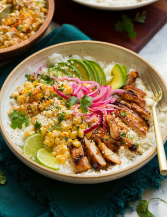Street corn and chicken rice bowl with avocado and pickled red onions.