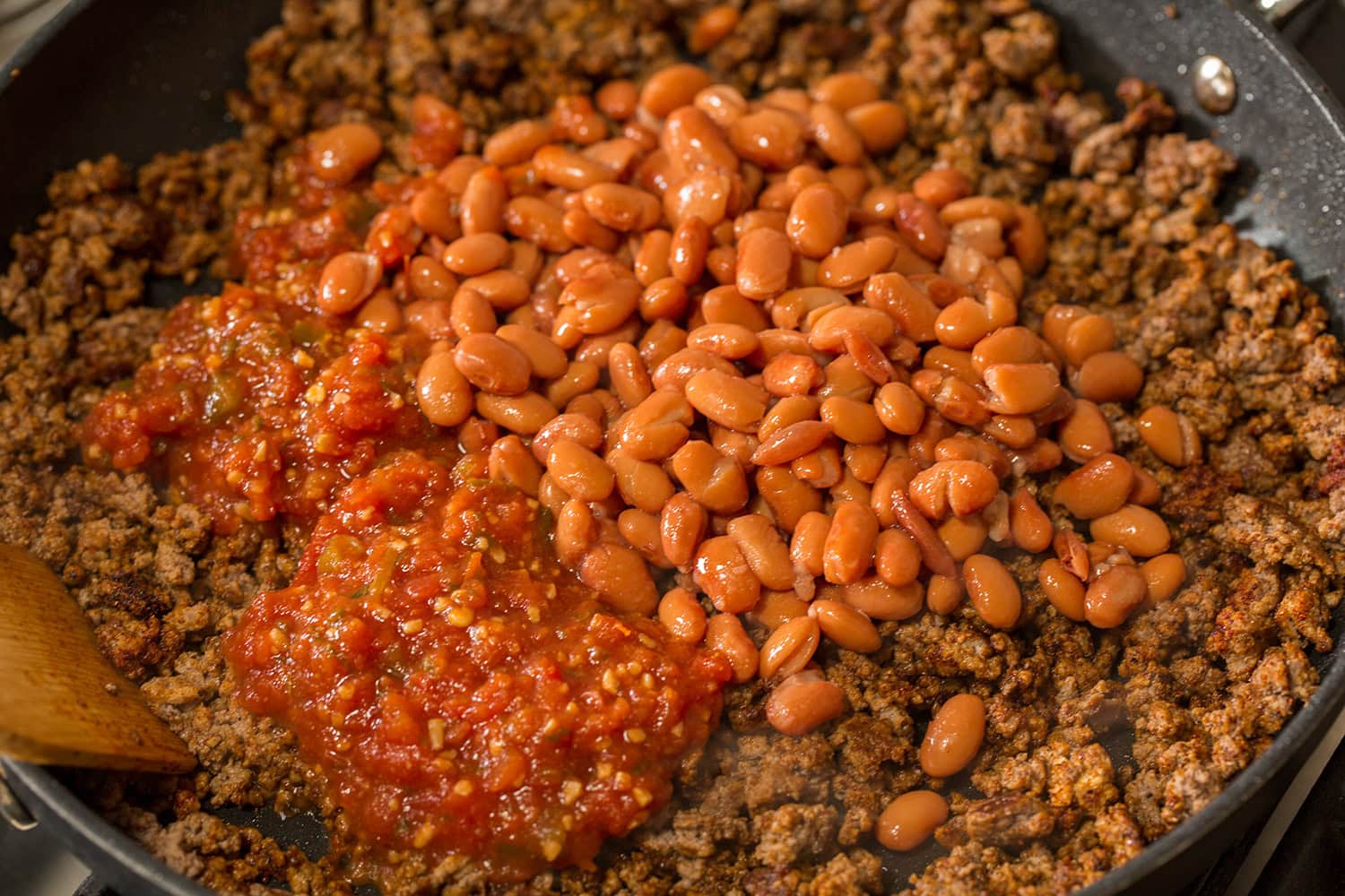Easy Beef Burritos Pinto beans and salsa added to seasoned browned beef.