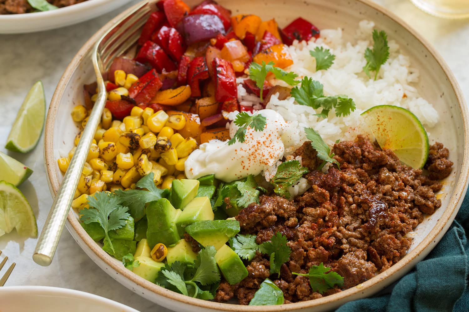 Photo showing how to assemble ground beef fajita bowls into a single serving dish.