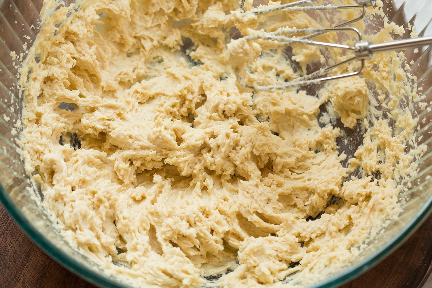 Egg shown blended into butter and sugar mixture.