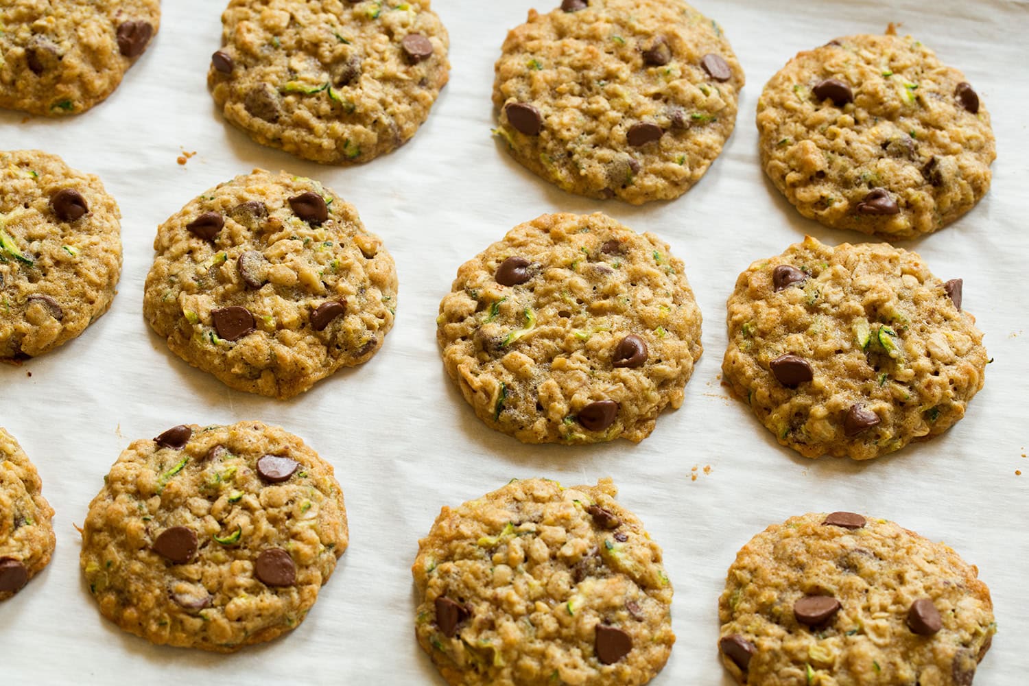 Zucchini oat cookies shown on baking sheet after baking.