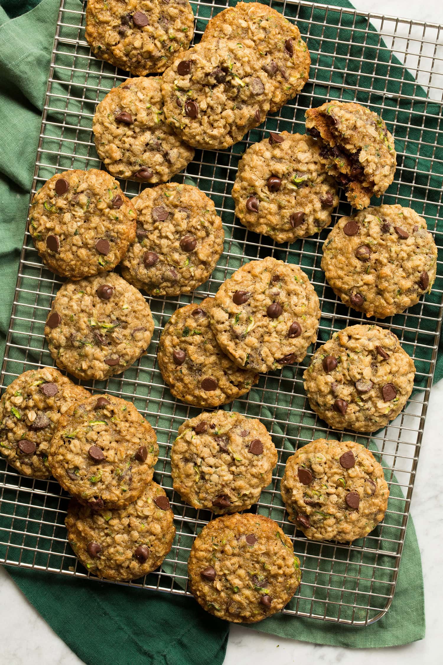 Zucchini oatmeal cookies on a silver cooling rack.