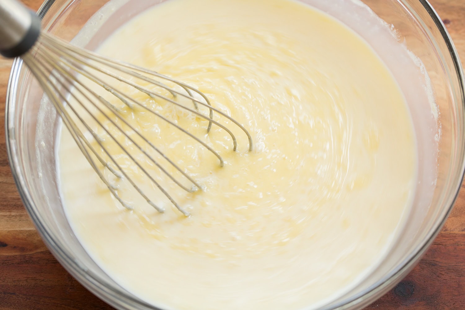 Cinnamon Roll Pancakes Milk, egg and butter mixture shown mixing.