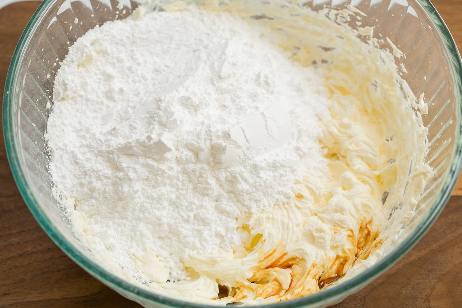 Cinnamon Roll Pancakes Powdered sugar and vanilla added to creamed butter and cream cheese in mixing bowl.